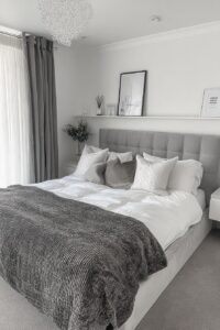 Arrange Contrasting Throw Pillows for Visual Interest on Grey Bed